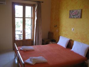 a bedroom with a bed with two towels on it at Thalia Hotel in Palekastron