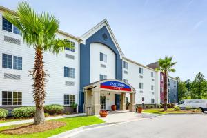 a palm tree in front of a building at Candlewood Suites Savannah Airport, an IHG Hotel in Savannah