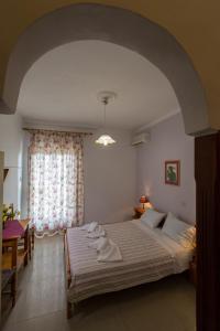 a bedroom with a large bed with towels on it at Filoxenia Studios 1 in Palaiochóra