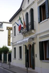 a building with two flags on top of it at Hotel Cris in Mestre