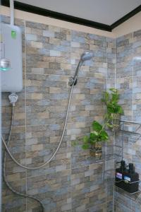a shower with a shower head in a bathroom at Little B house in Ban Tao Than