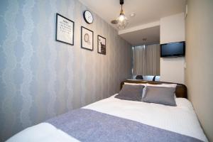 Giường trong phòng chung tại Vail sta Takenotsuka