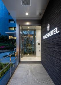 a building with the front door of a wyss hospital at Wires Hotel Shinagawa Seaside in Tokyo