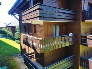 a building with a deck and a balcony at OURSONS 1 in Morillon