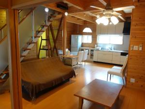 a living room and kitchen with a staircase in a house at machiyado Kuwanajuku Honmachi 10 in Kuwana