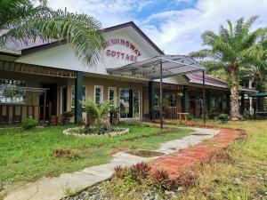 a building with an umbrella in front of it at Hemingway Cottage 海明威度假屋 in Semporna