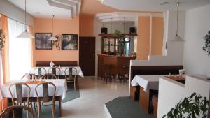 a restaurant with tables and chairs in a room at Penzion Jany in Luhačovice
