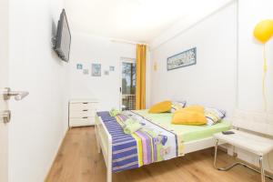 a bedroom with a bed and a television in it at Apartments Dobronic in Jelsa