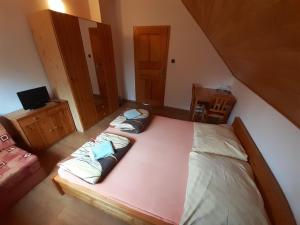 a bedroom with two beds and a couch and a tv at Apartmány Jarmila in Dolní Moravice