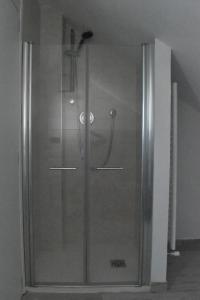 a shower with a glass door in a room at B&B Villa Paola in Savona