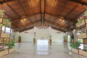 a large room with a table and potted plants at Hotel El Paso in Vejer de la Frontera