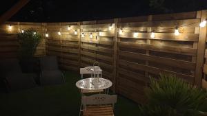 a patio with a table and chairs and lights at L escapade amoureuse in Bournezeau