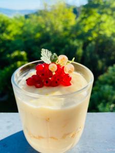 a dessert in a glass sitting on a table at Family Hotel Friends Villa in Enchets