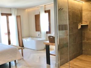 a bathroom with a tub and a sink and a shower at Hotel Abaco Altea in Altea