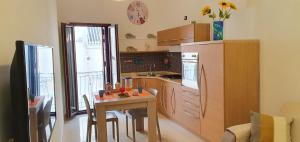 a kitchen with a small table and a kitchen with a dining room at Storico 3 in Monopoli