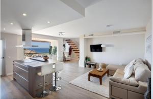 a kitchen and living room with a couch and a table at AMAZING DUPLEX NEXT TO THE BEACH IN MARBELLA in Marbella