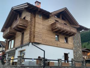 a house with wooden balconies on the side of it at Chalet dal Grant in Livigno