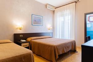Postel nebo postele na pokoji v ubytování Hotel Riviera