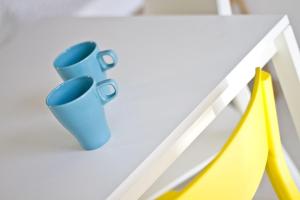 two blue cups sitting on a white desk at Cresta Beach Studios in St. Julianʼs