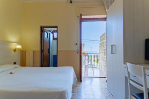 Postel nebo postele na pokoji v ubytování Hotel Riviera