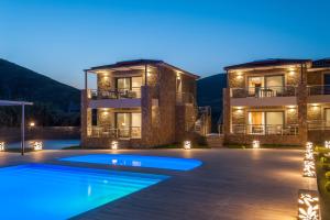 a villa with a swimming pool at night at Costa D' Ifesto in Agios Ioannis Kaspaka