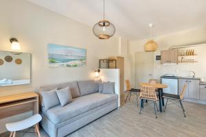 a living room with a couch and a table at Guesthouse ERI in Kini