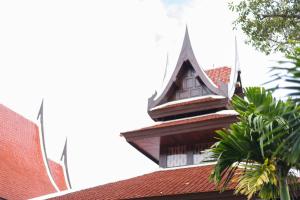 a building with a tower on top of a roof at Panviman Chiang Mai Spa Resort in Mae Rim
