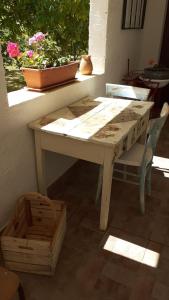 a table and a chair sitting next to a window at Agriturismo S'Armidda in Seùlo