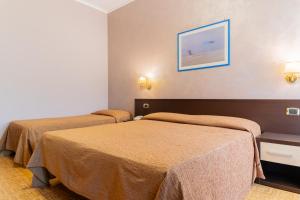 Postel nebo postele na pokoji v ubytování Hotel Riviera