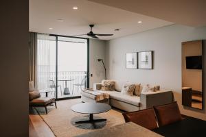a living room with a couch and a table at The Sebel Yarrawonga Silverwoods in Yarrawonga