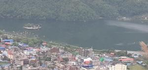 a city with a body of water and a city at Hotel Sunflower in Pokhara