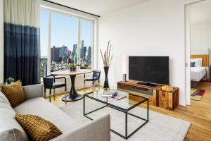 a living room filled with furniture and a tv at Hotel Indigo Lower East Side, an IHG Hotel in New York