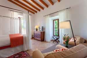 a living room with a bed and a couch at Finca Hotel Son Palou in Orient