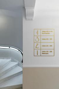 a set of stairs with a sign on the wall at Belle Epoque Suites in Athens