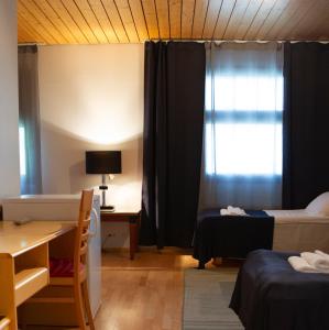 Cama o camas de una habitación en Hotelli Peltohovi