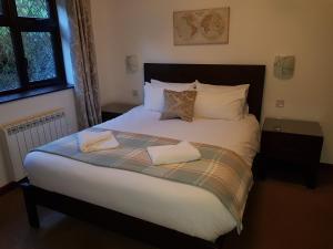 a bed with two towels on it in a bedroom at Bay Lodge in Birchington