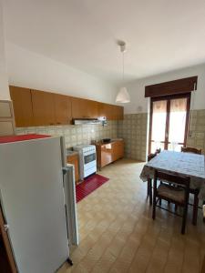 a kitchen with a table and a dining room at Belvedere Experience Apartment in Caprioli