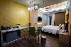 a hotel room with a bed and a television at JC Mark Hotel in Bintulu