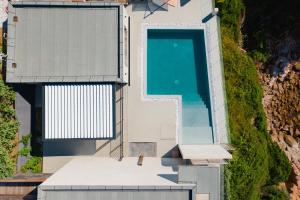 an overhead view of a house with a swimming pool at Hotel le Jardin d'Emile in Porticcio