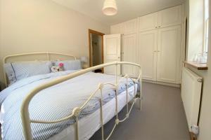 1 dormitorio con 1 cama con marco de metal en Delf Stream, close to town with lovely sunny terrace, en Sandwich