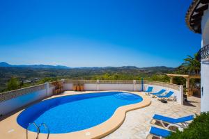 a swimming pool on the side of a house at Mirador al Sur in Moraira