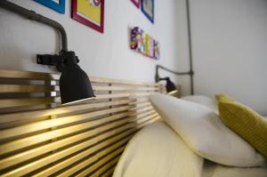 a bedroom with a bed with a light above it at Cresta Beach Studios in St. Julianʼs