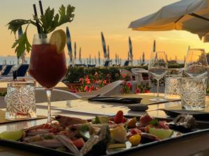 a table with a plate of food and a drink at Hotel Rex in Livorno