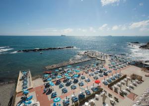 an aerial view of a beach with umbrellas and the ocean at Hotel Rex in Livorno