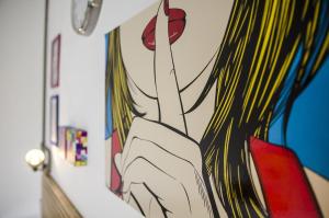 a painting of a woman in a room at Cresta Beach Studios in St. Julianʼs