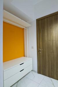 a room with a closet and a wooden door at Cresta Beach Studios in St. Julianʼs