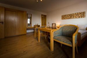 a living room with a wooden table and chairs at Landgasthof Ritter in Villingen-Schwenningen