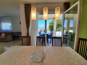 a dining room table with a view of a living room at Villa Smilje YourCroatiaHoliday in Drenje