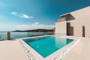 a swimming pool on the roof of a house at Hotel le Jardin d'Emile in Porticcio