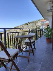 a balcony with a table and chairs and a view at Room Domo in Senj